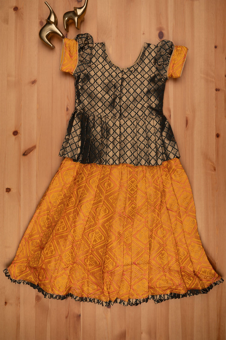 The Nesavu Pattu Pavadai Majestic Brocade Green Peplum Blouse paired with Patola Yellow Pattu Pavadai: Timeless South Indian Fashion Nesavu Pattu Pavadai with neck designs | Girls traditional silk dresses | The Nesavu