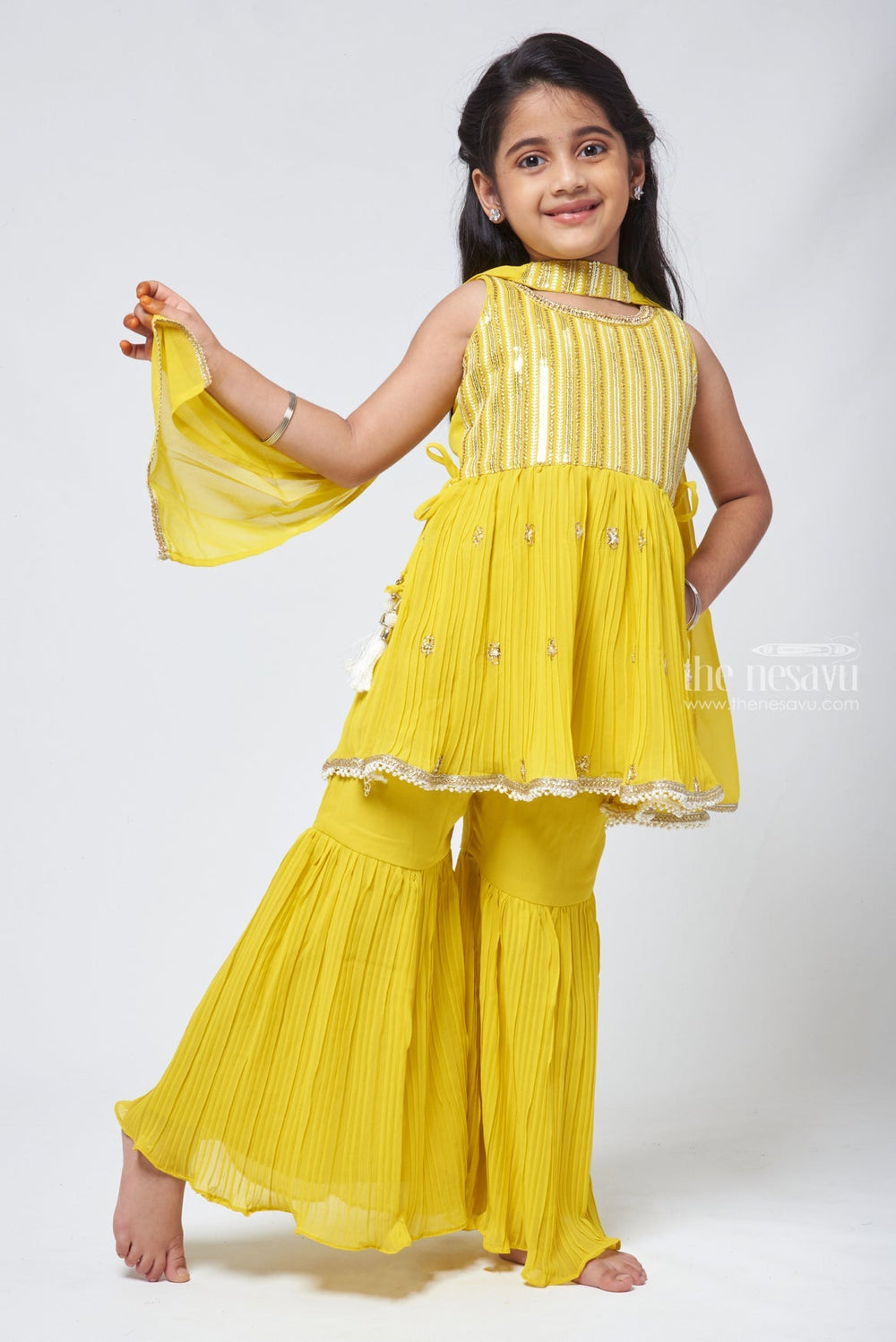 The Nesavu Sets & Suits Majestic Zari Embroidered Yellow Peplum Kurti with Palazzo Suit: Indian Traditional Flair. Nesavu Majestic Zari Embroidered Yellow Peplum Kurti with Palazzo Suit: Indian Traditional Flair