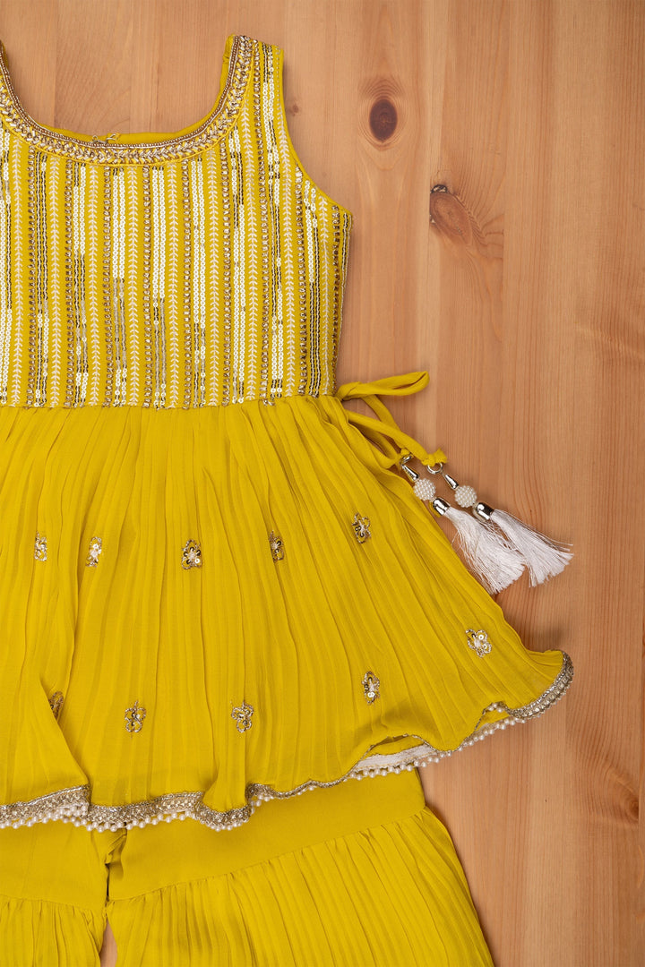 The Nesavu Sets & Suits Majestic Zari Embroidered Yellow Peplum Kurti with Palazzo Suit: Indian Traditional Flair. Nesavu Majestic Zari Embroidered Yellow Peplum Kurti with Palazzo Suit: Indian Traditional Flair