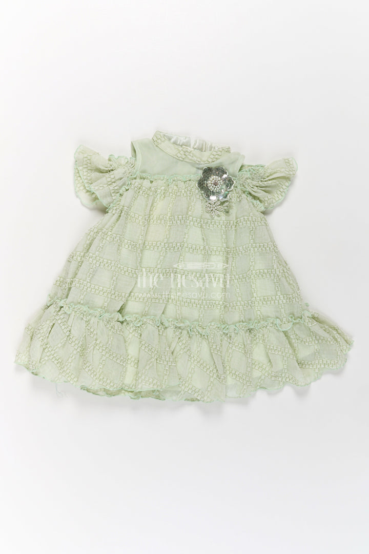 The Nesavu Girls Fancy Frock Organza Dress Frock for Girls in Light Green with Ruffle Hem and Floral Brooch Detail Nesavu Organza Dress Frock Girls Light Green Ruffles Embellished Floral Brooch | The Nesavu