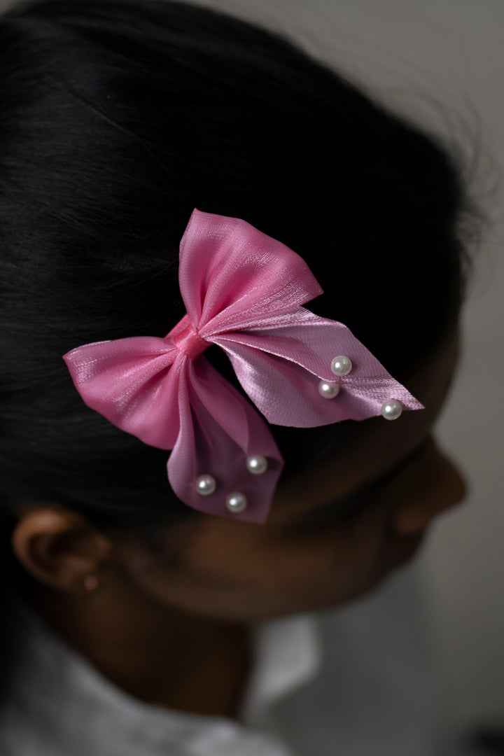 The Nesavu Hair Clip Pearl Accented Pink Satin Bow Hair Clip Nesavu Pink JHCL76G Chic Pink Satin Hair Bow with Pearl Accents | Playful Elegance for Every Occasion | The Nesavu