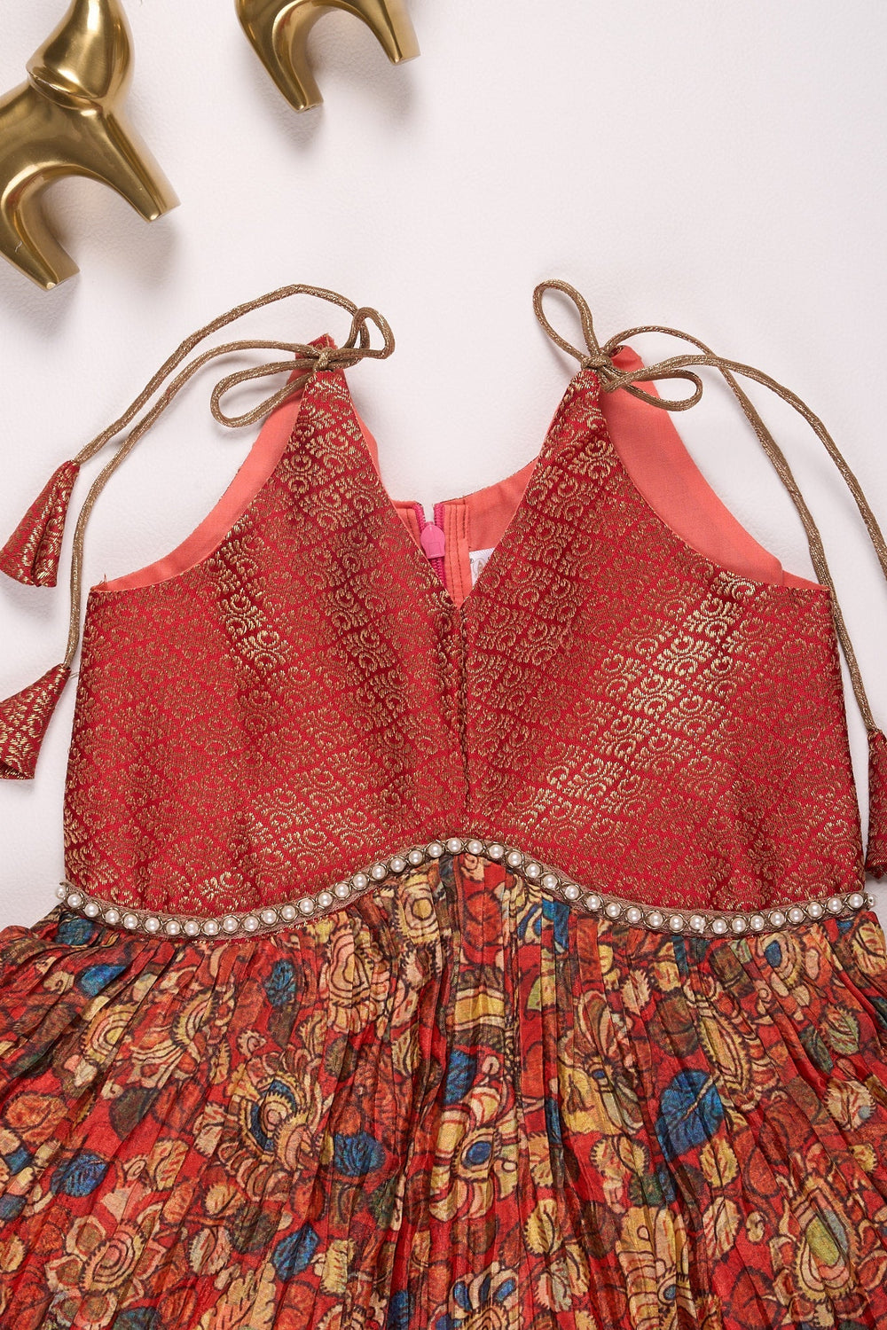 The Nesavu Tie-up Frock Rust Orange and Multicolor Ethnic Dress for Girls Nesavu Orange and Maroon Pleated Chinon Designer Baby Frock with Tie-Up Straps - Stylish & Luxurious