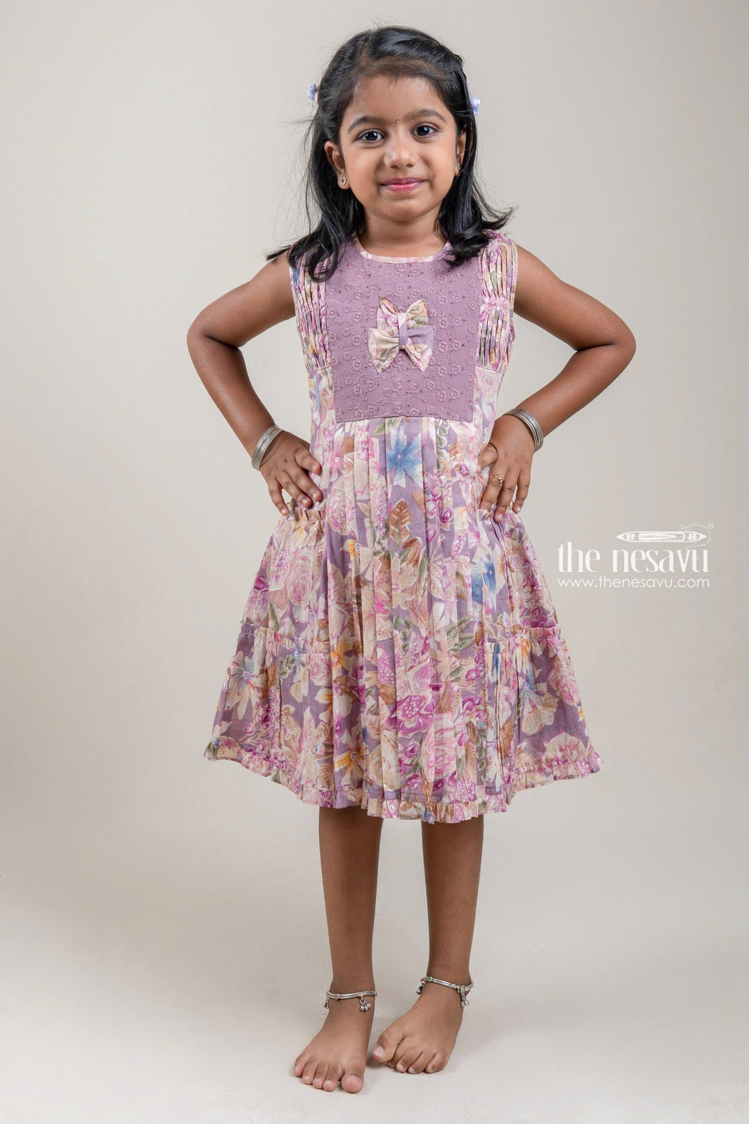 The Nesavu Girls Cotton Frock Stunning Purple Floral Printed Pleated Girls Cotton Frock With Bow Applique Nesavu 22 (4Y) / Purple / Rayon GFC1035B-22 Girls Frock Suit | Trendy Cotton Frock Collection | The Nesavu