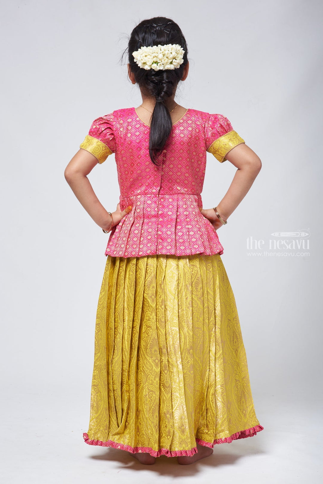 The Nesavu Pattu Pavadai Stylish Brocade Pink Peplum Blouse and Banarasi Green Pattu Pavadai: Perfect for Celebrations Nesavu Pattu Pavadai Latest Design | Pattu Pavadai for baby girl online | The Nesavu
