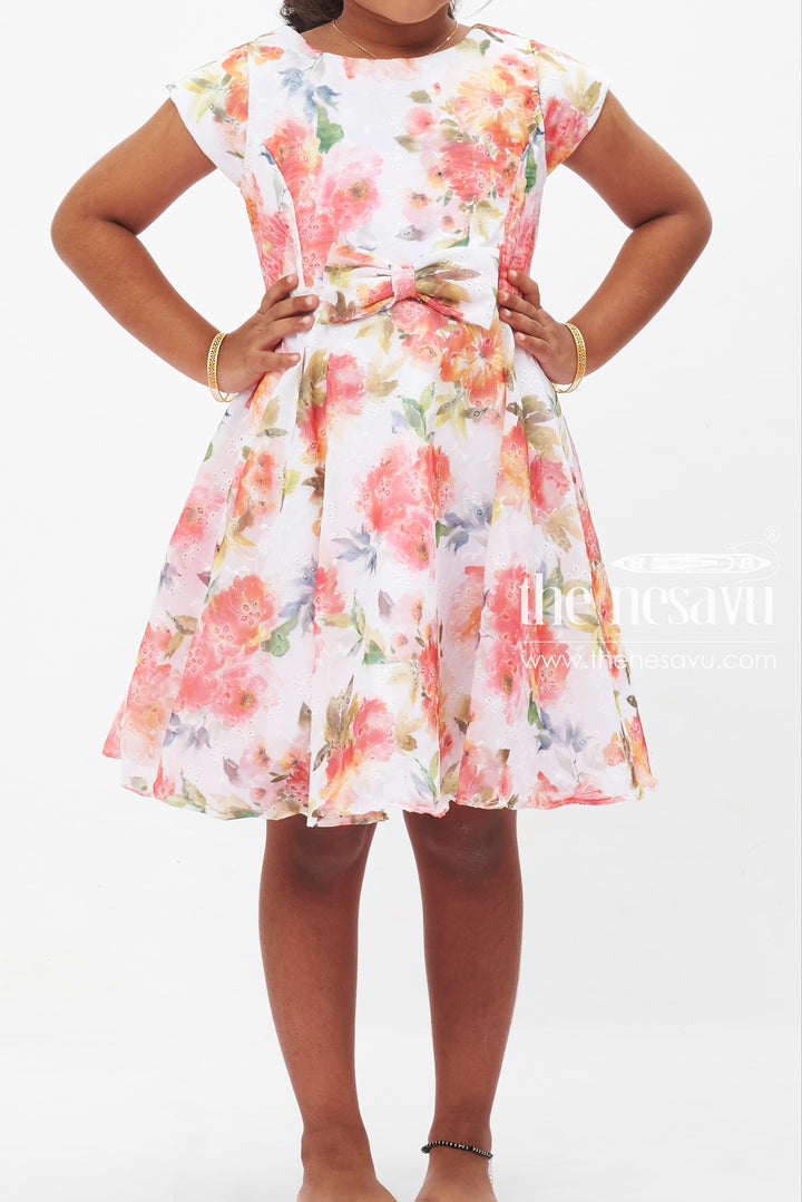 The Nesavu Girls Fancy Frock Summer Bloom Elegance Dress: Vibrant Floral Printed Frock for Girls with Bow Accent Nesavu Girls Floral Summer Dress | White Frock with Vivid Flowers | Playful Bow Detail | The Nesavu