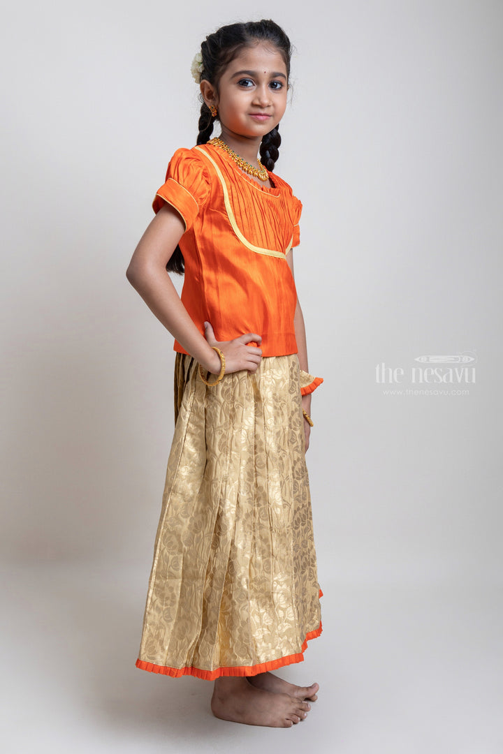 The Nesavu Pattu Pavadai Traditional Orange Silk Blouse With Beige Banarasi Pleated Designer Pattu Pavadai For Girls Nesavu Silk Pavada For Girls | Premium Silk Frock Onine | The Nesavu