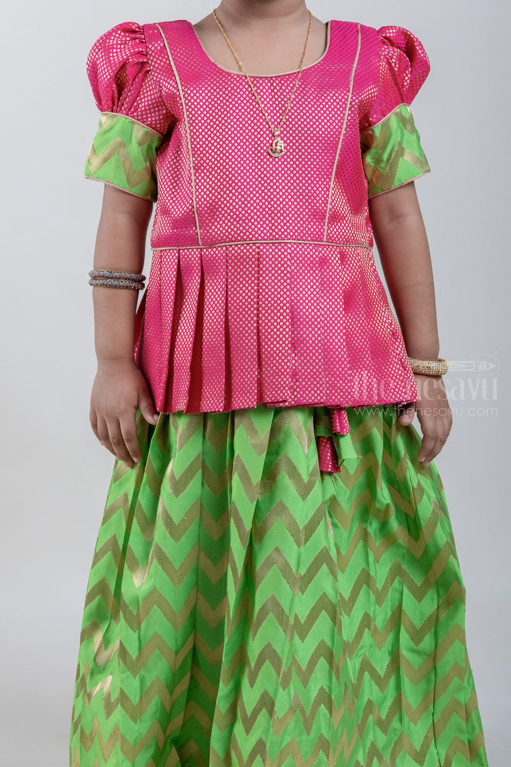 The Nesavu Pattu Pavadai Traditional Pink Brocade Designer Silk Blouse with Green Silk Skirt for Girls Nesavu Ethnic Pink Brocade Silk Blouse with Green Silk Skirt | Traditional Pattu Pavadai |The Nesavu