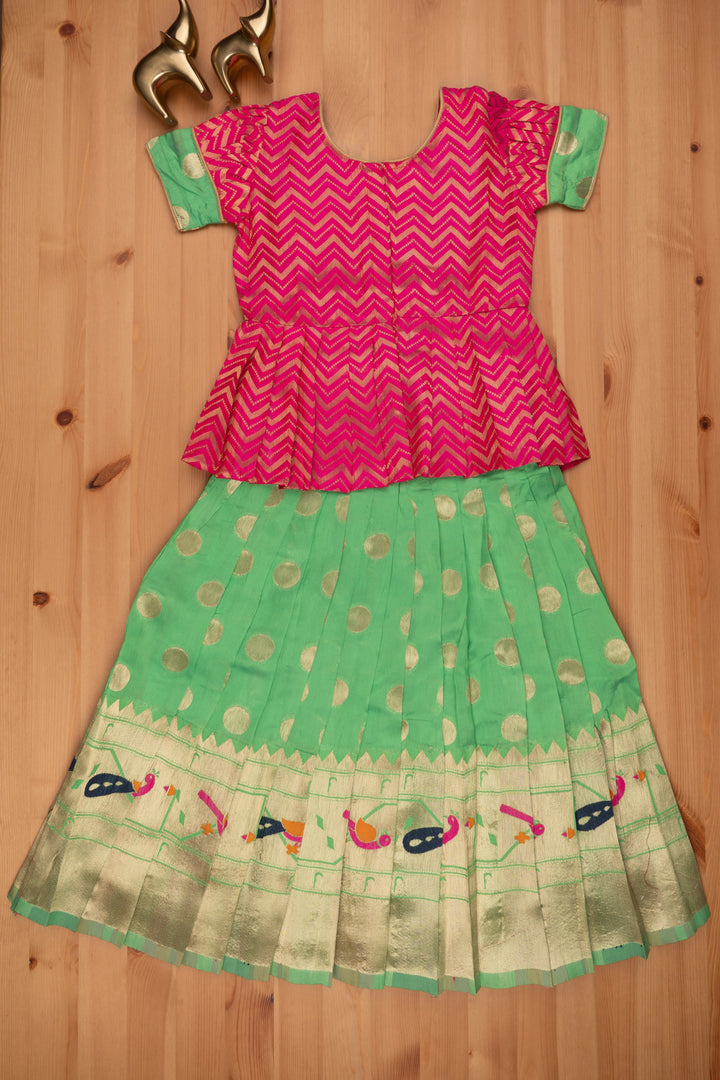 The Nesavu Pattu Pavadai Trendy Zig Zag Pink Peplum Blouse with Zari Butta Green Pattu Pavadai: Heritage Silk Collection Nesavu Pattu Pavadai with zari border | Pattu Pavadai Online Shopping | The Nesavu