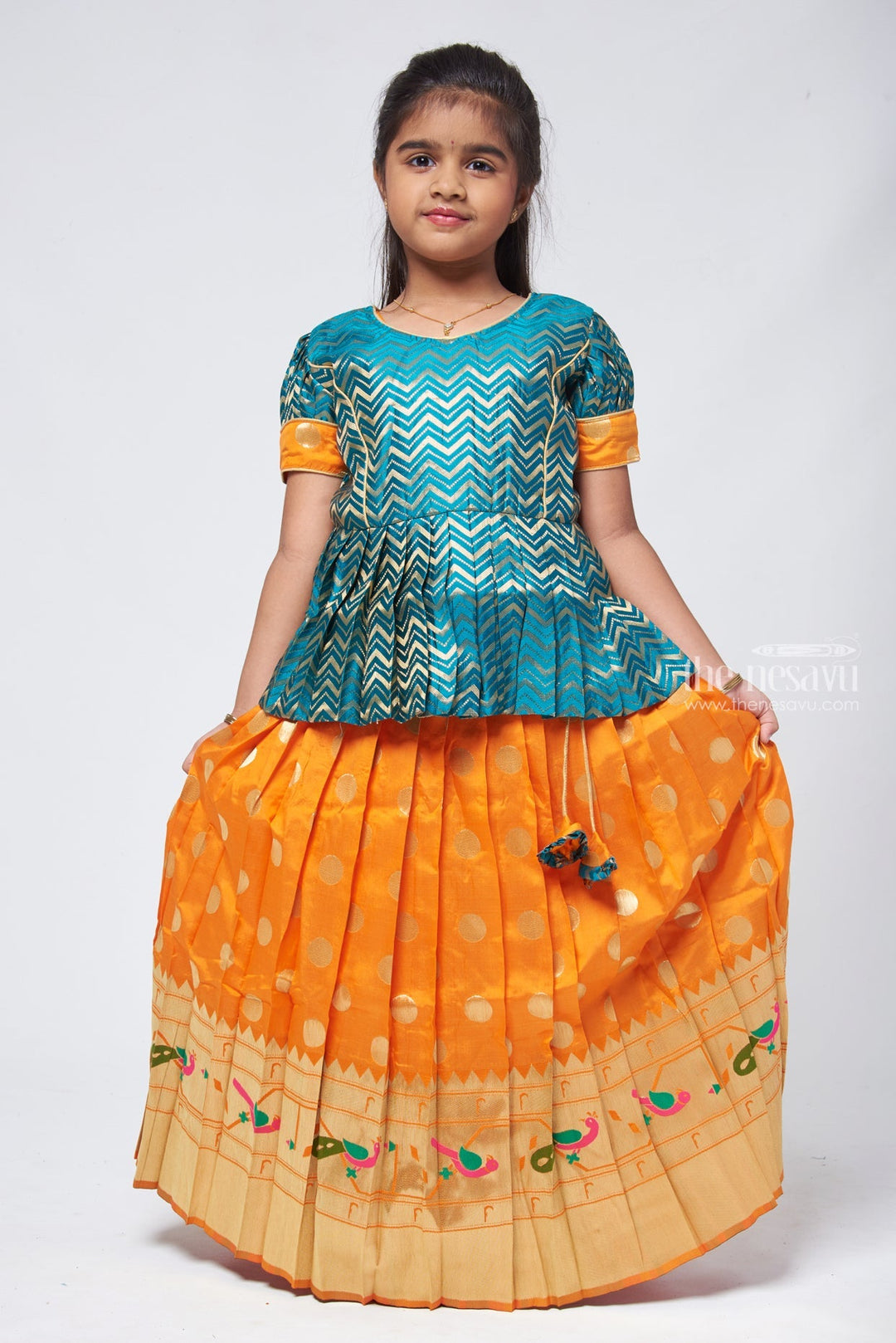 The Nesavu Pattu Pavadai Vibrant Zig Zag Green Peplum Blouse with Zari Butta Orange Pattu Pavadai: Traditional Festive Charm Nesavu Pattu Pavadai Latest Design | Pattu Pavadai for Festivals | The Nesavu