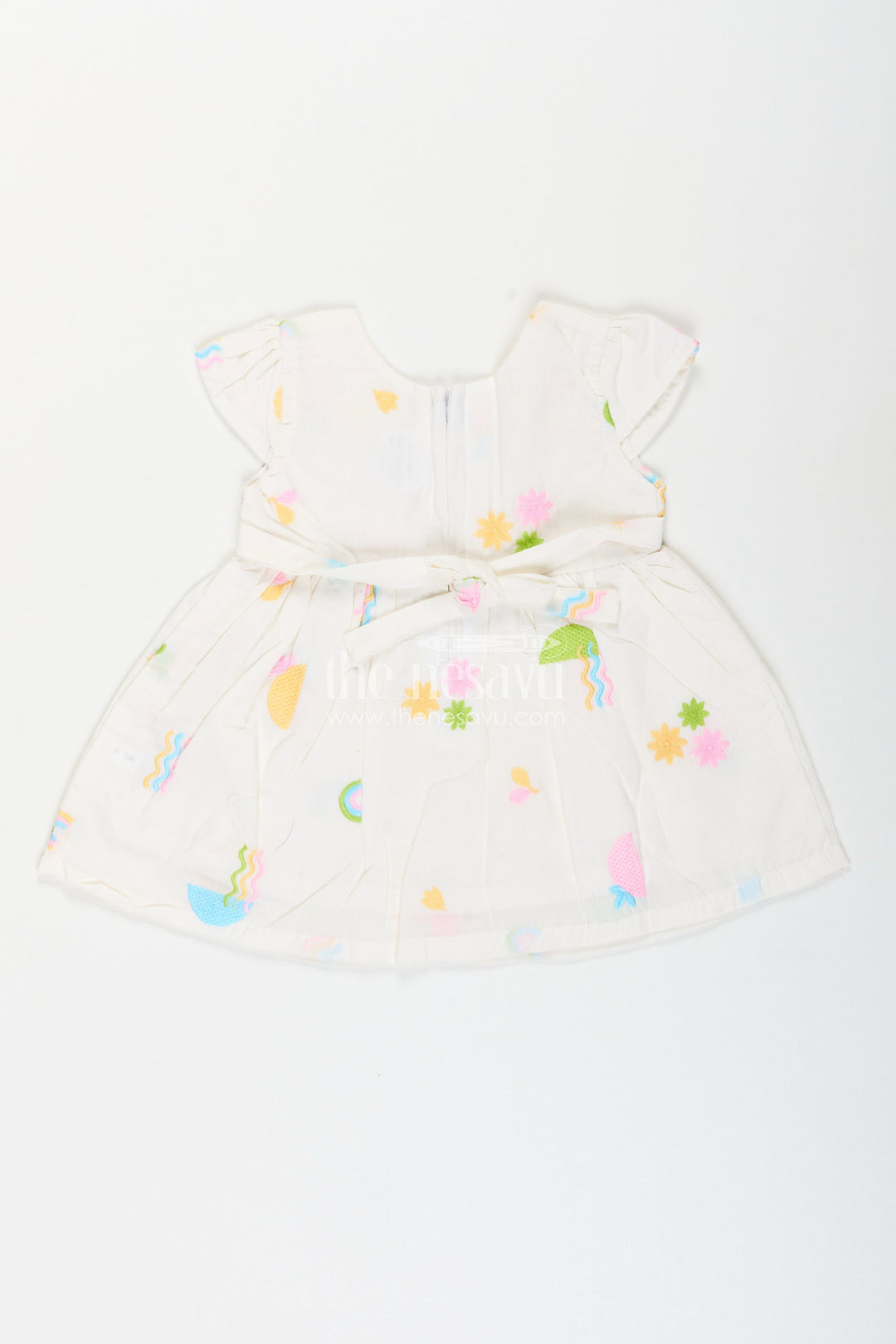 The Nesavu Baby Cotton Frocks White baby girl frock with pastel embroidery for everyday wear Nesavu Nesavu white baby girl frock with pastel rainbow embroidery and flutter sleeves for casual wear