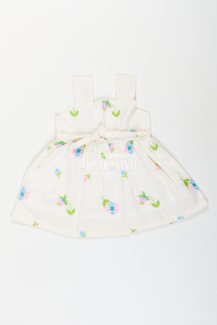 The Nesavu Baby Cotton Frocks White cotton frock with floral embroidery and shoulder straps for baby girls Nesavu Nesavu white cotton frock for baby girls with shoulder straps and colorful floral embroidery