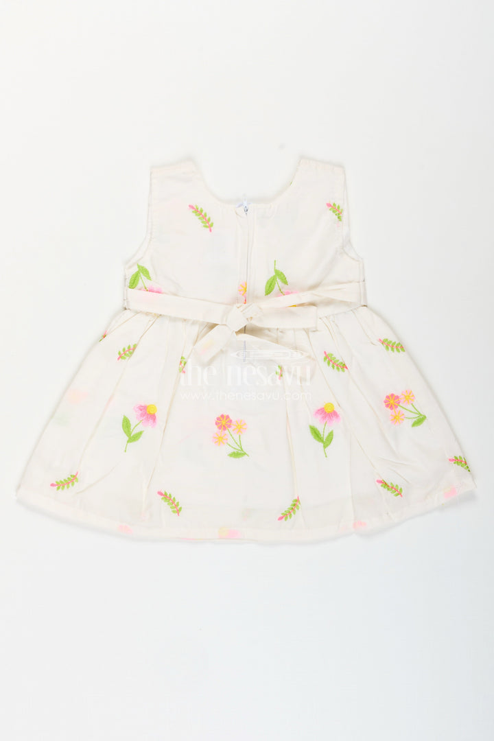 The Nesavu Baby Cotton Frocks White frock for baby girls with floral embroidery and waist bow Nesavu Nesavu white cotton frock for baby girls with bow and floral embroidery for casual dressing