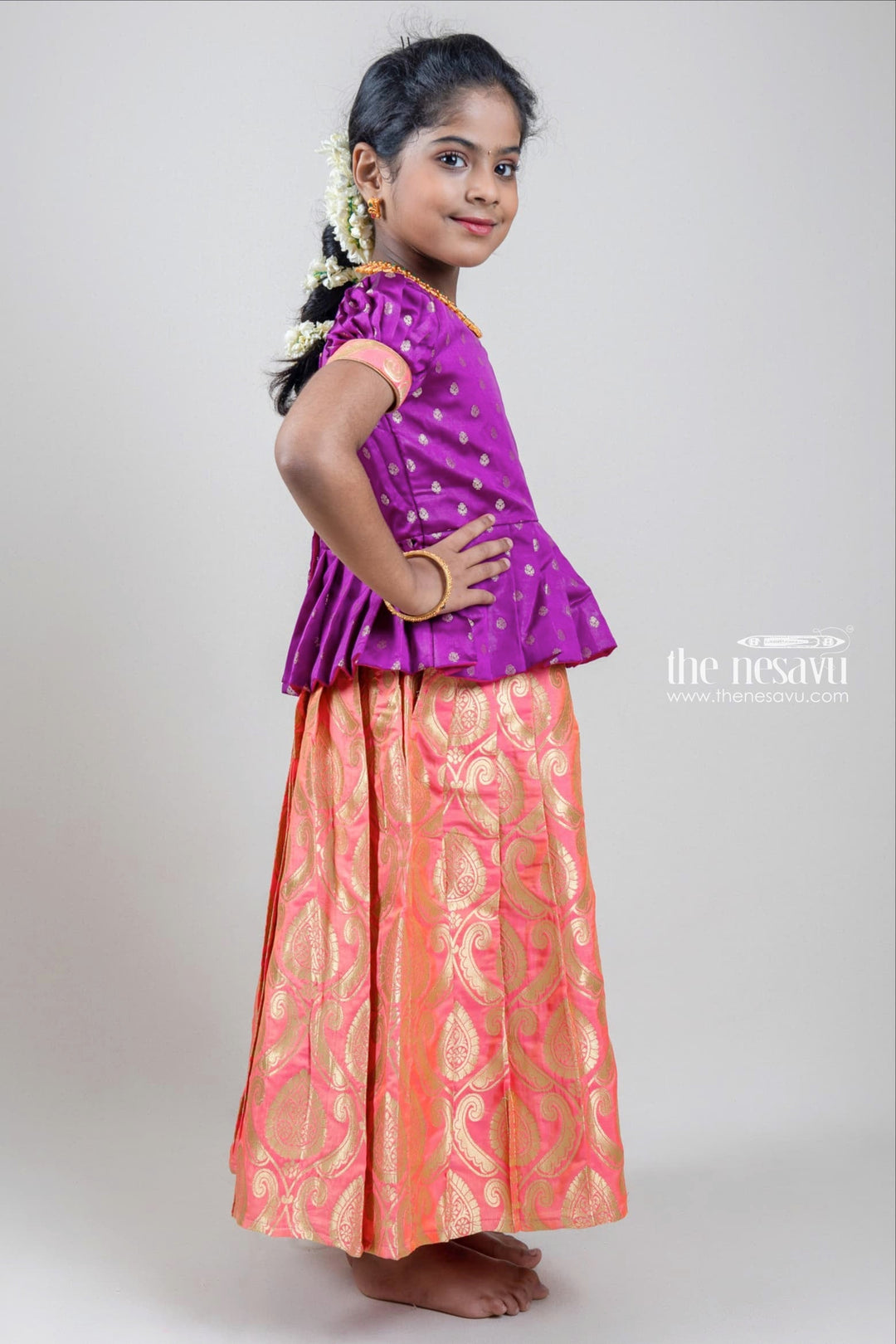 The Nesavu Pattu Pavadai Zari Butta Printed Purple Silk Peplum Blouse with Knife Pleated Pink Pattu Pavadai for Girls Nesavu Zari Butta Printed Purple Silk Peplum Blouse with Knife Pleated Pink Pattu Pavadai for Girls | Shop at The Nesavu