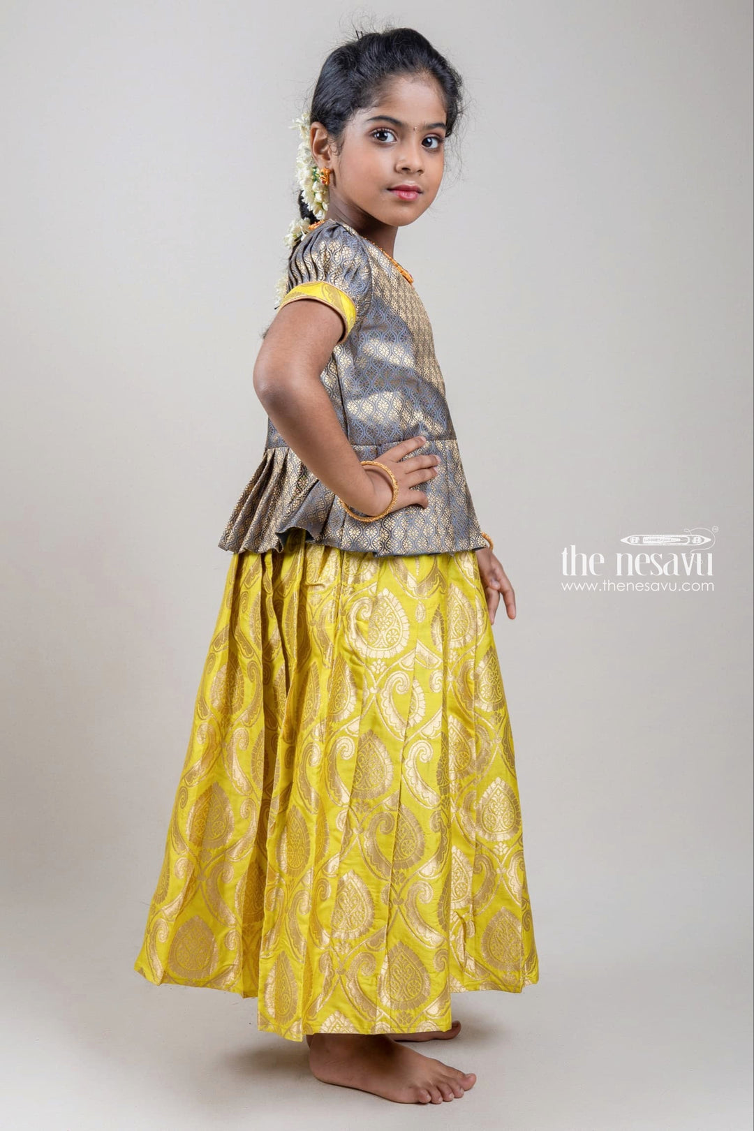 The Nesavu Pattu Pavadai Zari Floral Designer Brown Blouse with Knife Pleated Green Silk Skirt for Girls Nesavu Zari Floral Designer Brown Blouse with Knife Pleated Green Silk Skirt for Girls | Full Length | Shop at The Nesavu